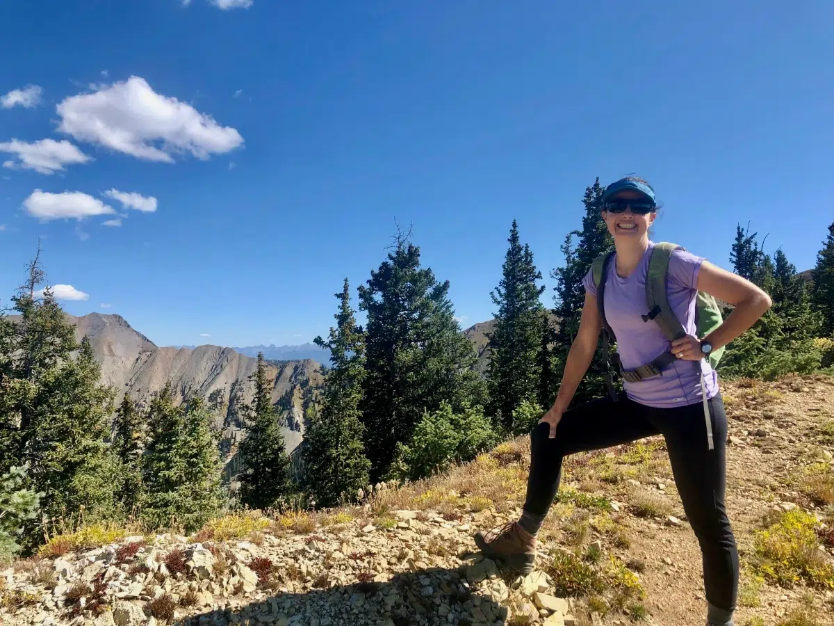 Woman hiking on a sunny day. Achieve IBD remission and get back to your best life.